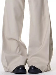 Men's beige wide-leg sweatpants with button details at the ankle.