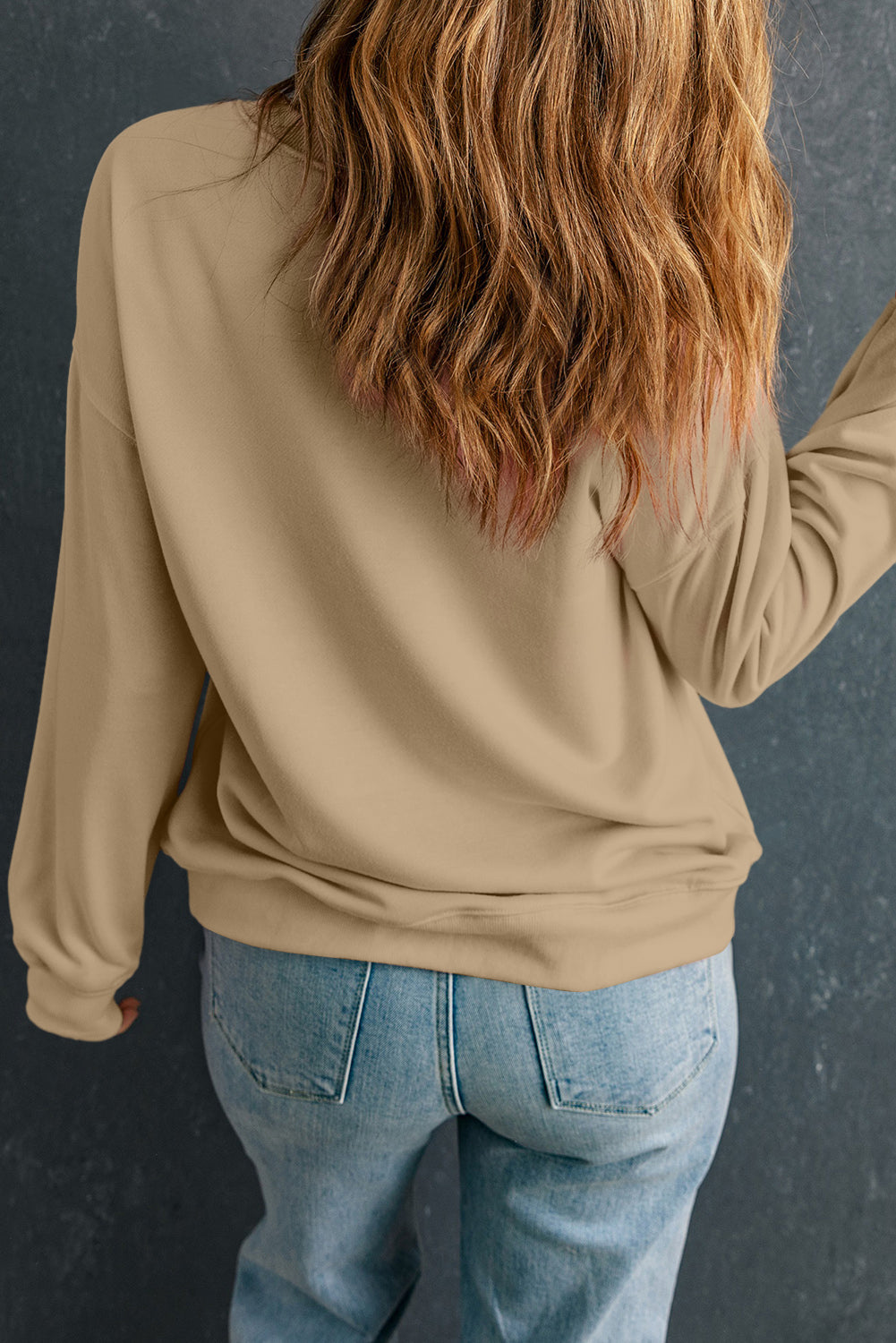Khaki sweatshirt with a floral pumpkin graphic on the back, casual crewneck style.