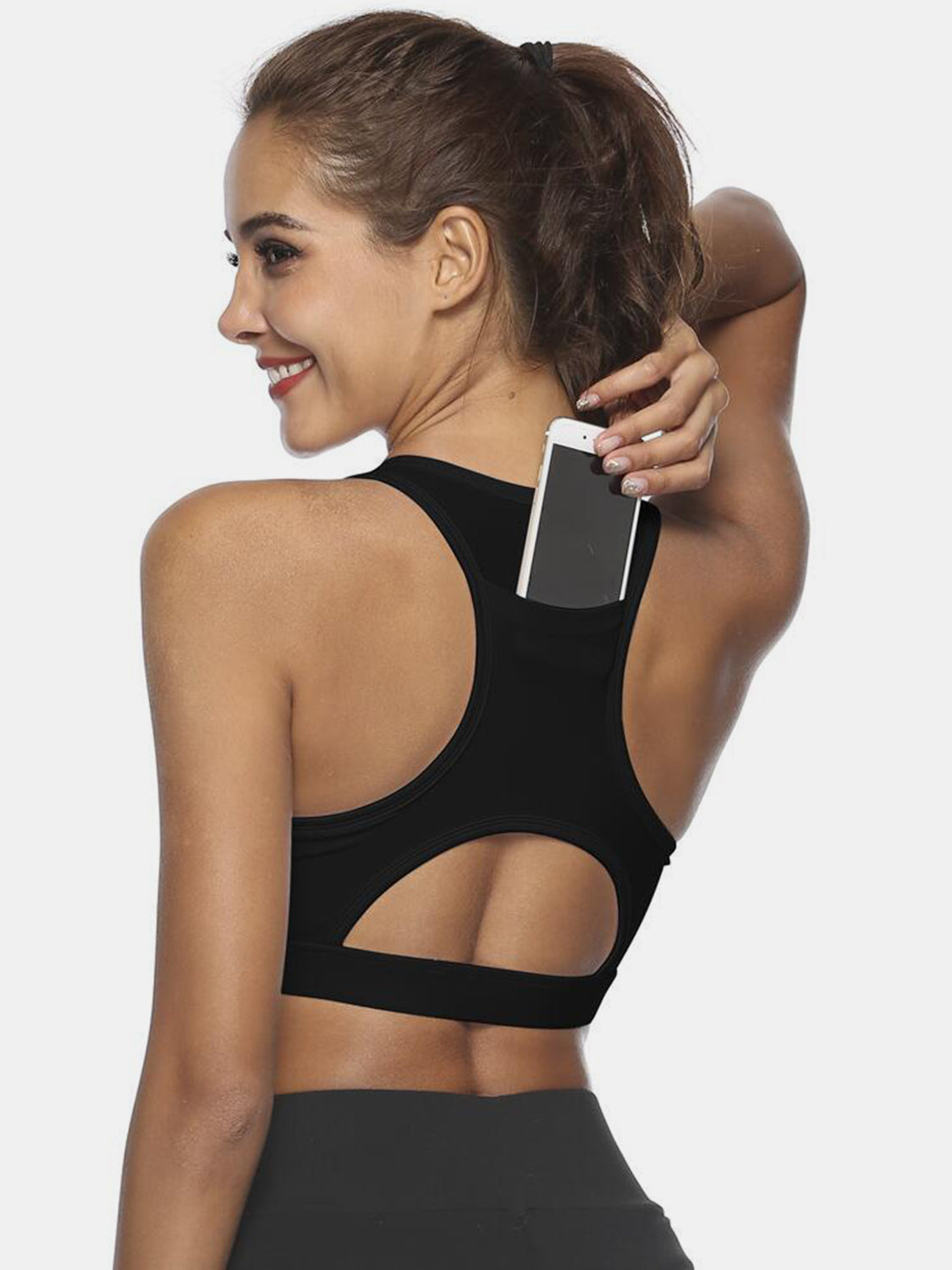 Black racerback sports bra with phone pocket and cutout detail