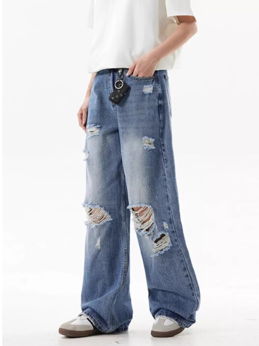 Men's distressed wide-leg jeans in light wash denim with ripped details.