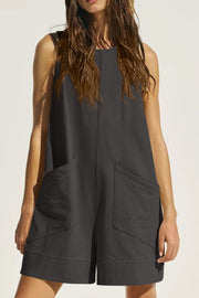 Dark gray linen romper with pockets and a relaxed fit.