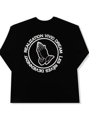 Black long sleeve tee with white praying hands graphic and text circle
