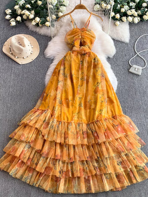 Yellow floral mesh maxi dress with ruched bodice and tiered ruffle skirt.