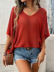 Rust open-knit dolman sleeve v-neck sweater with textured knit detail.