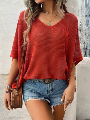 Rust open-knit dolman sleeve v-neck sweater with textured knit detail.