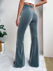 Teal textured corduroy bell bottom trousers with a high waist.