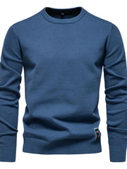 Peacock Blue crew neck knit sweater with ribbed cuffs and hem, featuring a small logo patch.