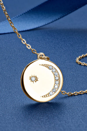 Gold necklace with celestial moon and star pendant with crystal accents