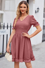 Dusty pink textured dot puff sleeve fit-and-flare dress with V-neck and ruffled hem
