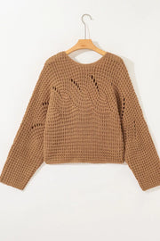 Brown chunky knit sweater with wide sleeves and open knit details