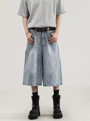Men's light wash denim relaxed fit wide-leg capris with cargo pockets and a raw hem.