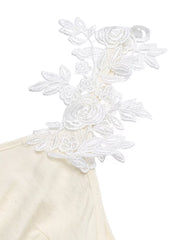 Beige maxi dress with white floral lace trim on the shoulder and V-neckline.