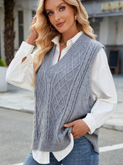 Gray cable knit V-neck sweater vest with diamond pattern detail.