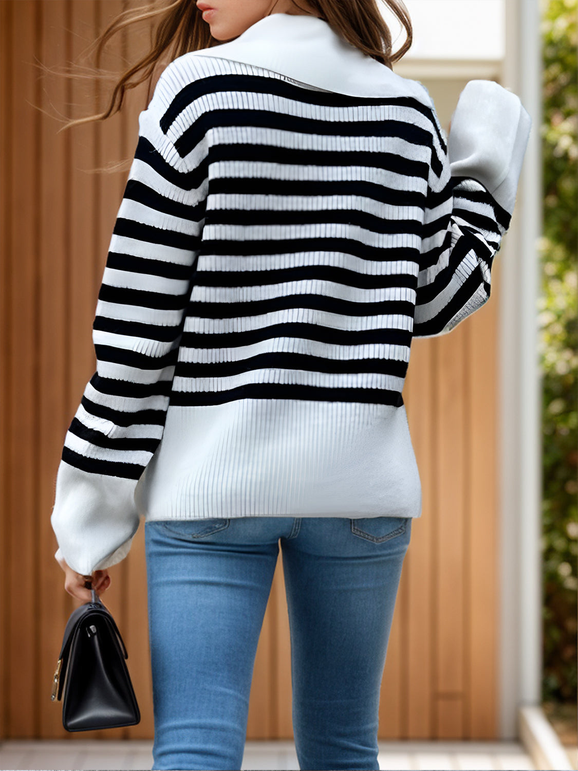 Breton stripe knit sweater with wide collar and ribbed cuffs, styled with blue jeans.