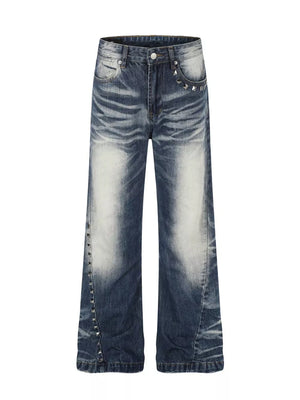 Distressed blue bootcut jeans with studded accents on pockets and leg seams.