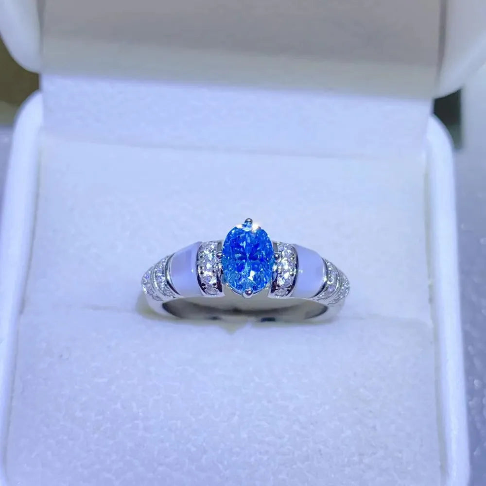 Silver ring with oval blue moissanite and mother-of-pearl accents