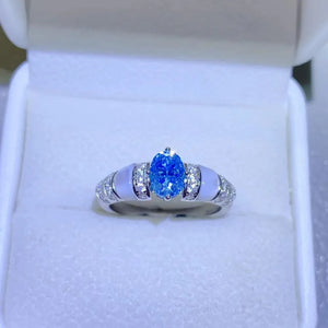 Silver ring with oval blue moissanite and mother-of-pearl accents