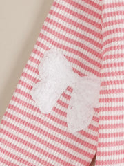 Baby set with pink and white stripes and a white bow accent.