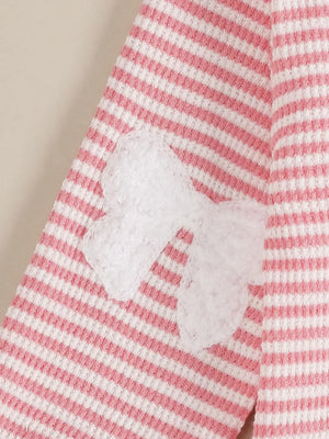 Baby set with pink and white stripes and a white bow accent.