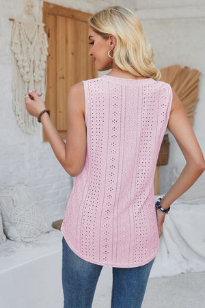 Blush pink sleeveless top with allover eyelet perforations and a curved hem.