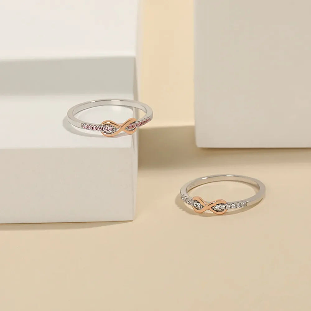Infinity knot ring with rose gold and diamonds, available in silver and blush pink.