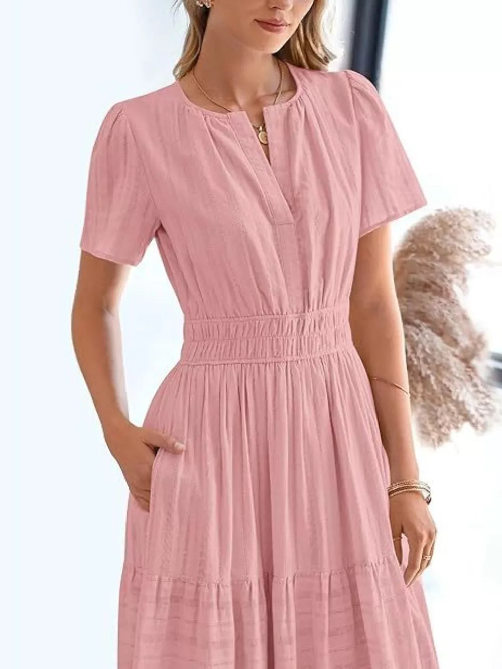Dusty Pink tiered midi dress with V-neck, short sleeves, and ruched waist.