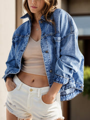 Oversized washed black denim trucker jacket with button closure.