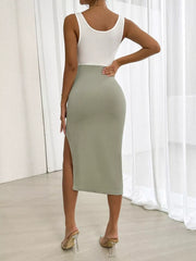 Asymmetrical two-tone midi dress in white and sage green with a high slit and bodycon fit.