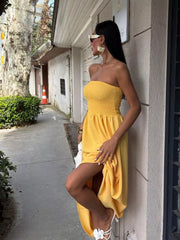 Yellow smocked bodice relaxed maxi dress with a strapless neckline and thigh-high slit.