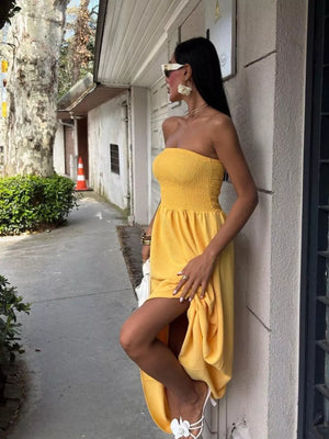 Yellow smocked bodice relaxed maxi dress with a strapless neckline and thigh-high slit.