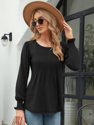 Black long sleeve blouse with pleated bodice and gathered cuffs.