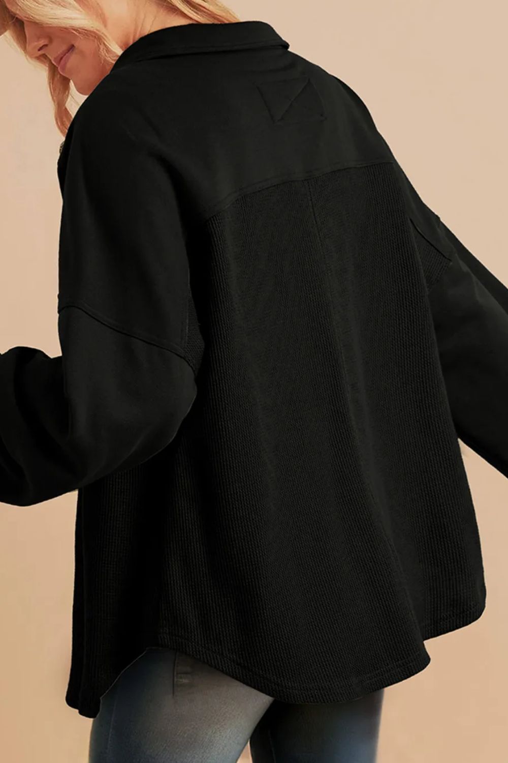 Black waffle knit shacket with gathered sleeves and collar detail.