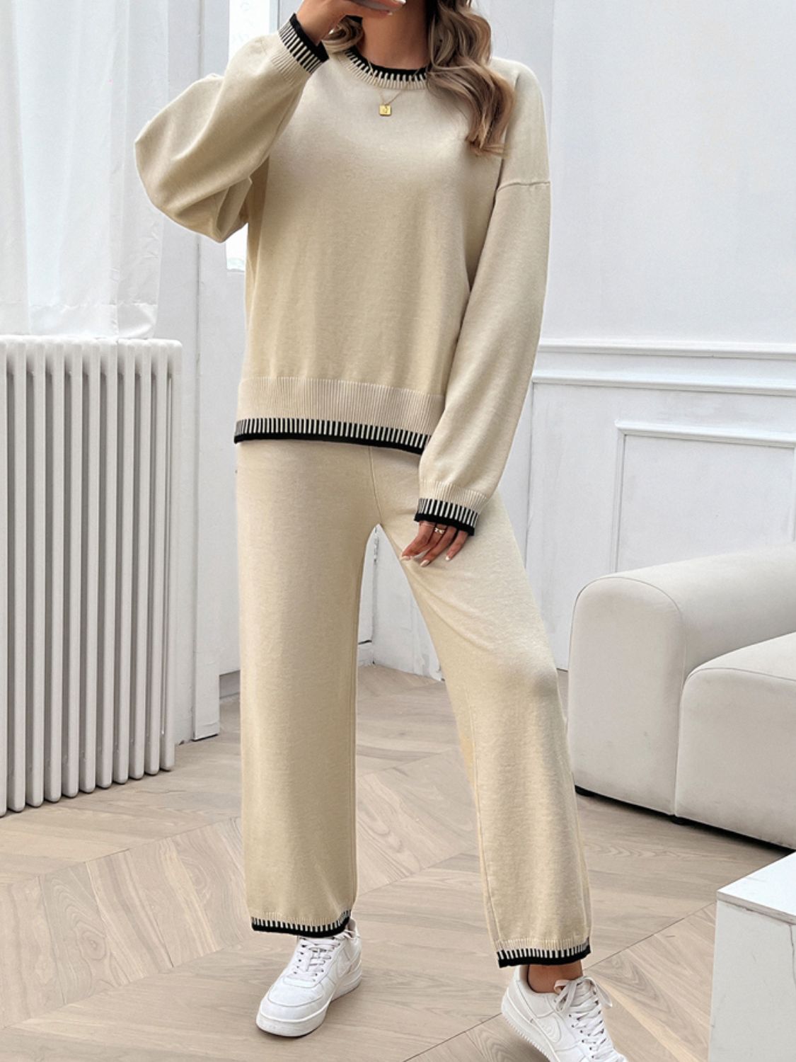 Beige knit lounge set with ribbed trim on crewneck, cuffs, and hem.