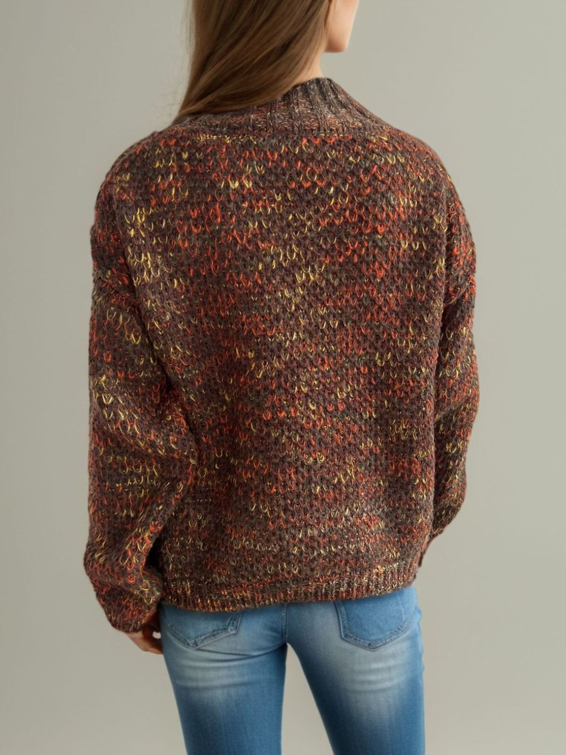Textured mélange mock neck pullover sweater in brown with multicolor flecks.
