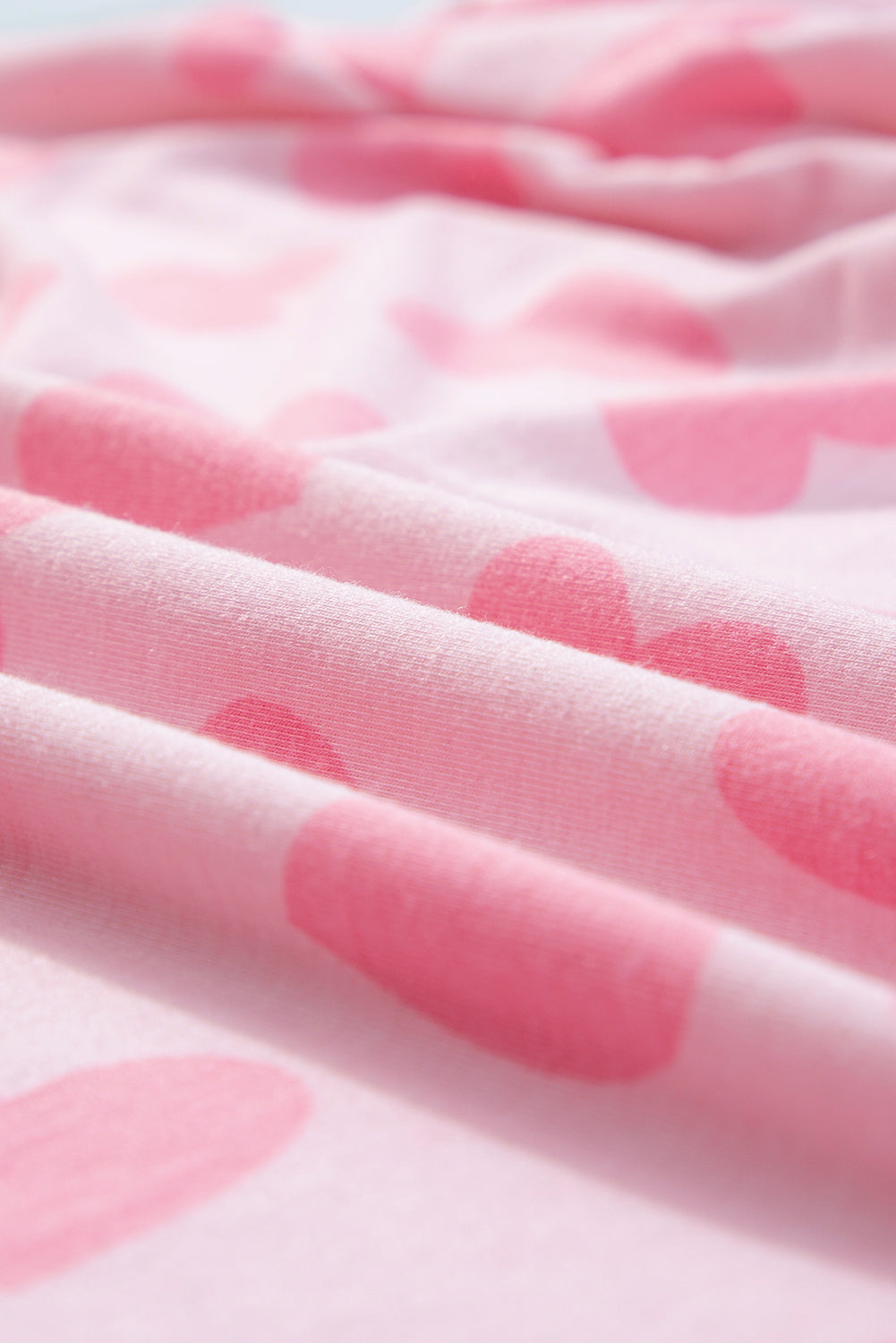 Blush pink lounge set with a heart print pattern.