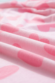 Blush pink lounge set with a heart print pattern.