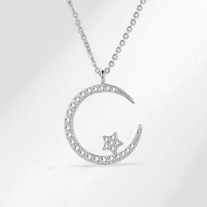 Silver crescent moon and star necklace with clear stones