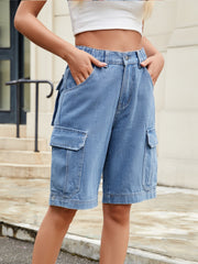 Medium wash denim cargo bermuda shorts with elastic waist and utility pockets.