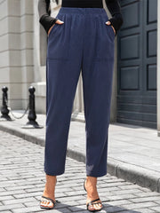 Navy corduroy relaxed fit trousers with elastic waist and front pockets.