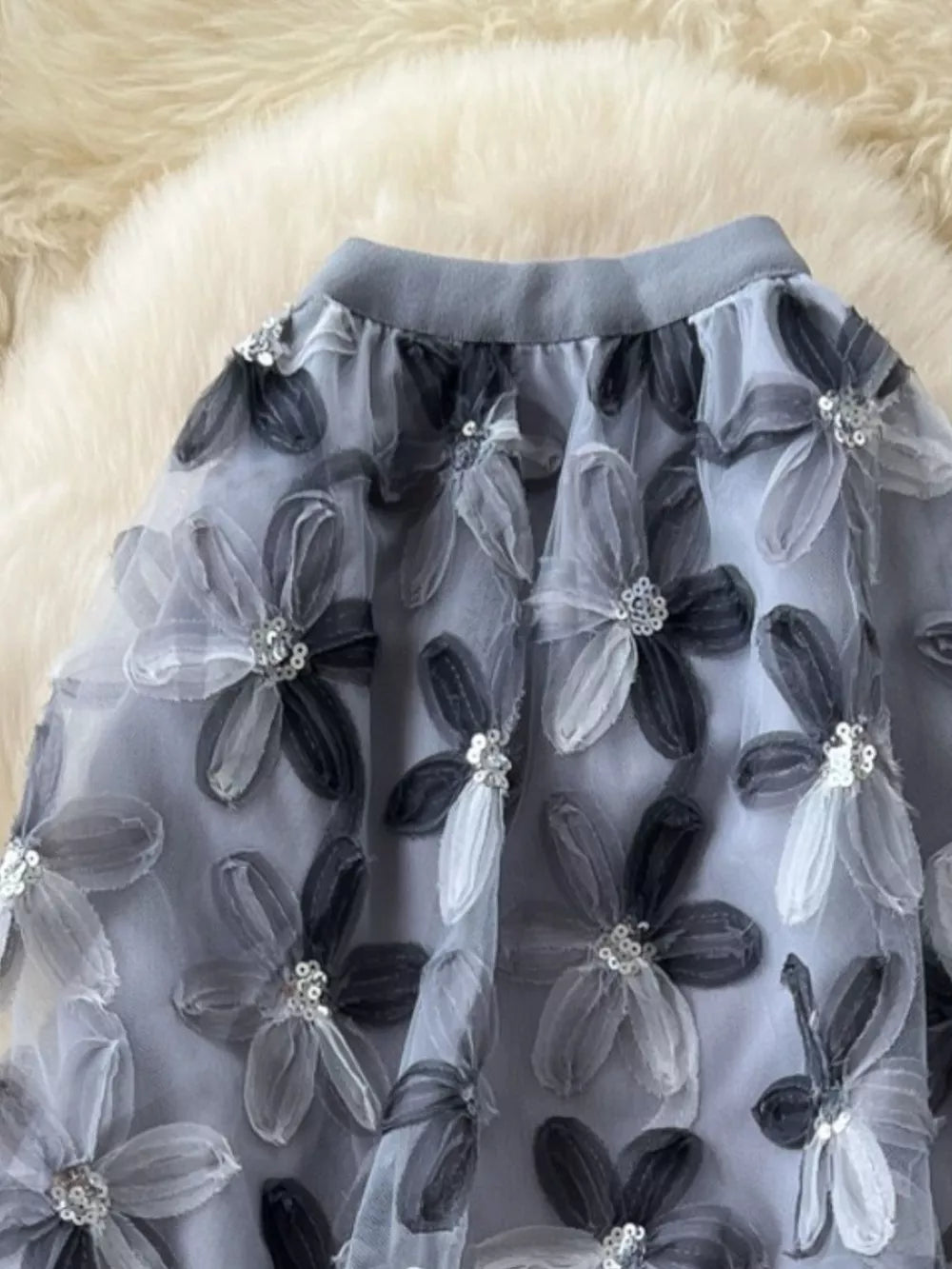 Layered gray skirt with embroidered floral appliques and sequin details.