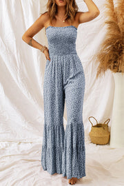Dark blue floral smocked bodice strapless jumpsuit with flare legs and tiered ruffles.