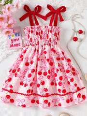Pink cherry print smocked toddler dress with red bow straps and ruffled hem