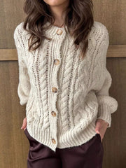 Ivory cable-knit button-down cardigan with wooden buttons and textured knit.