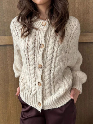 Ivory cable-knit button-down cardigan with wooden buttons and textured knit.