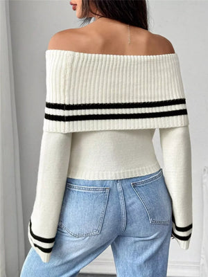 White off-shoulder knit sweater with black stripes and flare sleeves, cropped length.