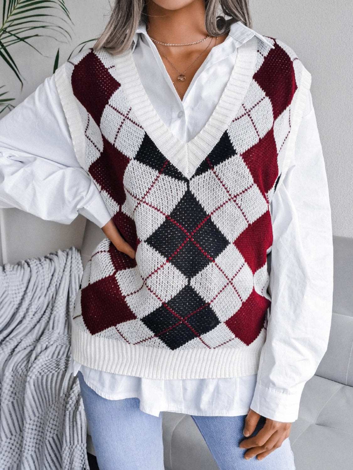 Argyle knit v-neck sweater vest in burgundy, white, and black.