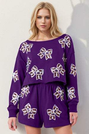 Purple cropped sweatshirt and shorts set with sequin bow details.
