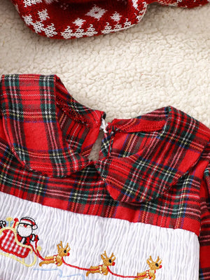 Baby dress with red plaid collar and smocked white bodice embroidered with Santa in a sleigh.
