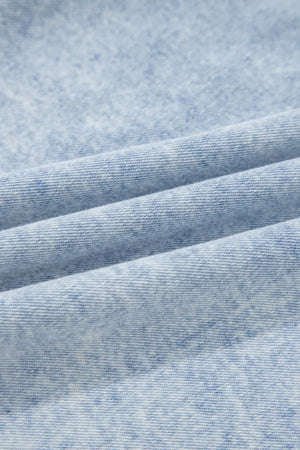 Light wash denim blouse with a textured, marbled pattern and visible weave.