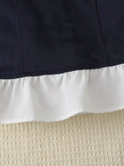 Navy polo dress detail with white ruffled hem